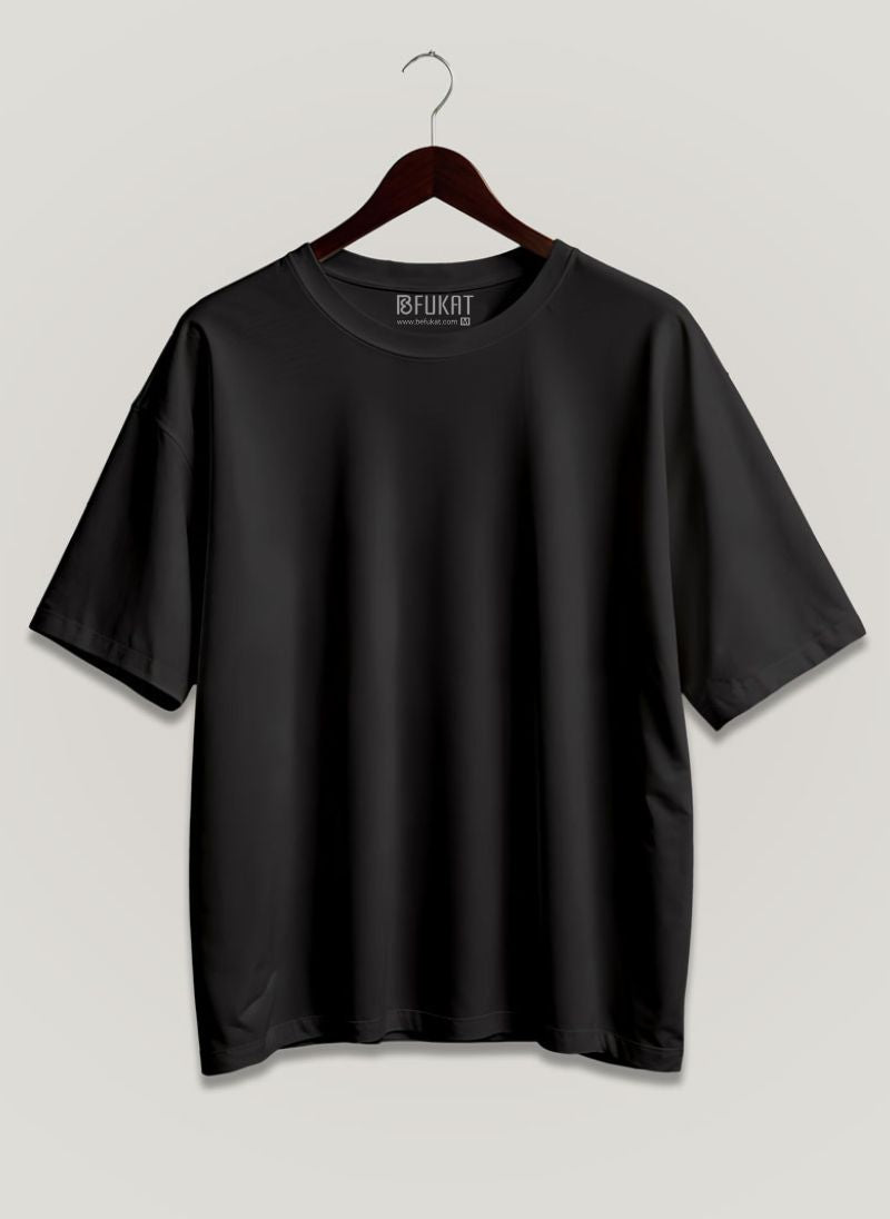 Black t-shirt on a hanger with a light gray background